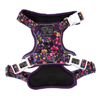 A floral patterned dog harness with adjustable straps, reflective trim, and branded buckles.