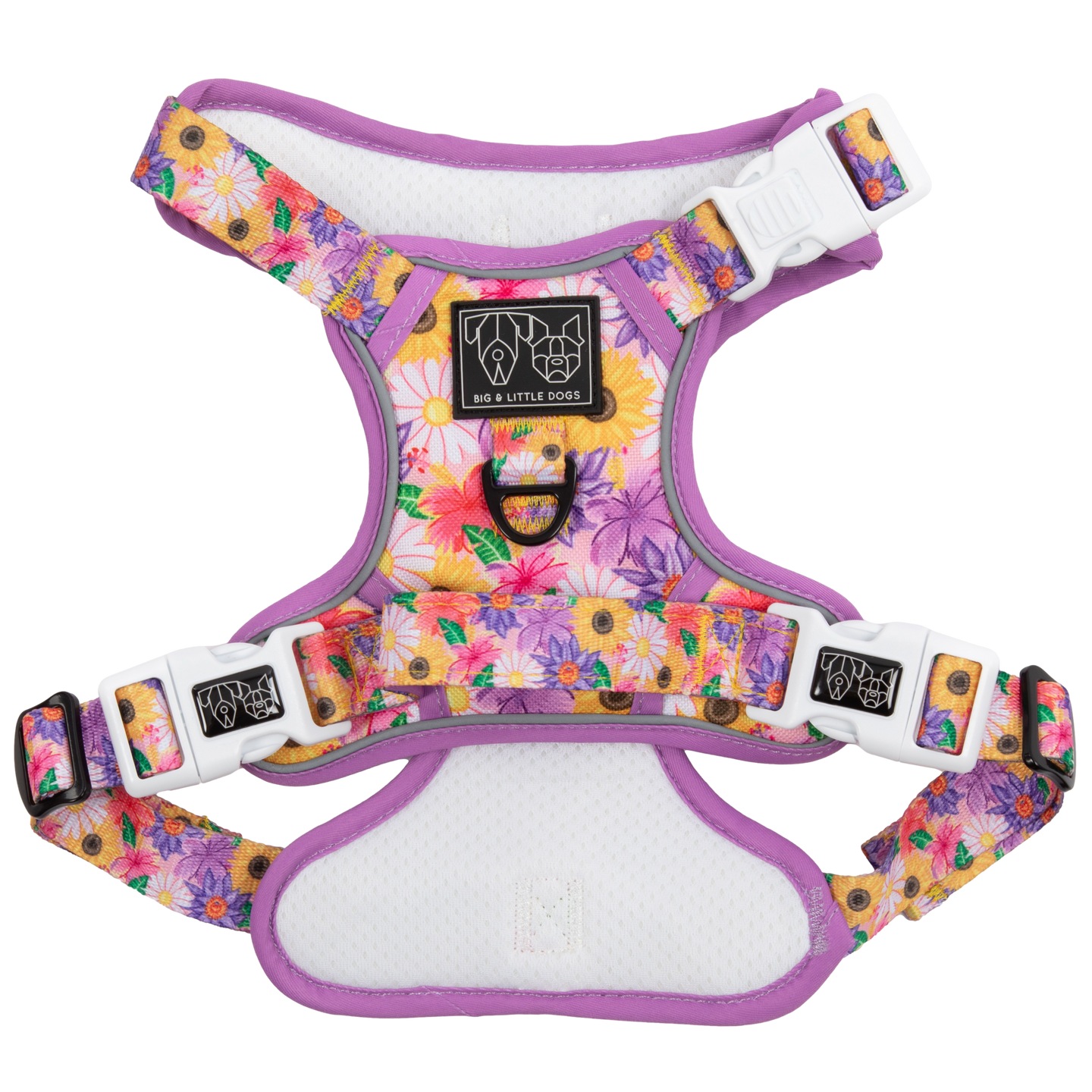 Adjustable dog harness with a floral pattern in pink, purple, and yellow colors, featuring white straps and a metal d-ring.