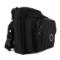 A black training pouch with multiple compartments, a branded rubber poop bag dispenser, and a key leash attached.