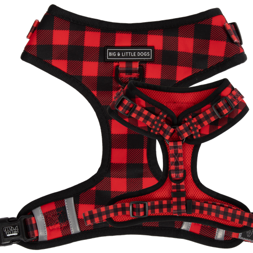 Adjustable dog harness with a plaid pattern in red and black, featuring reflective stripes, brand logos, and adjustable straps.
